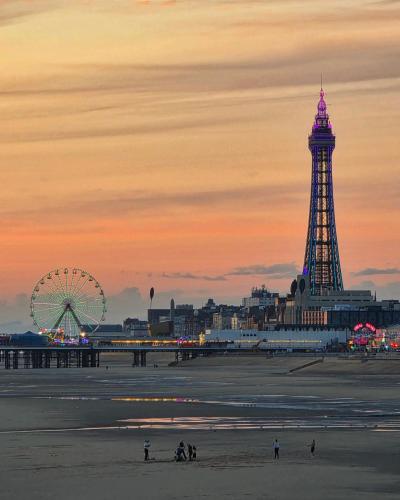 a beach with a ferris wheel and a ferris wheel at Hotel Rouge in Blackpool