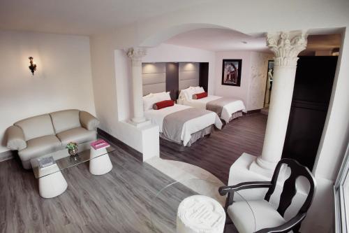 a hotel room with two beds and a couch at Hotel & Spa Hacienda Baruk in Zacatecas