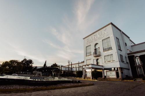 a white building with a fountain in front of it at Hotel & Spa Hacienda Baruk in Zacatecas