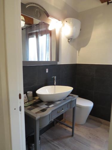 a bathroom with a sink and a toilet at Casale Santa Margherita in Bucine