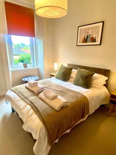 a bedroom with a large bed with towels on it at Ochil View in Stirling