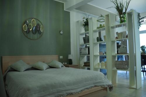 a bedroom with a bed and a clock on the wall at La Casetta di Gio' con Parcheggio in Lerici