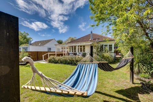 a hammock in the yard of a house at Bird and Fish - Napier Holiday Home in Napier