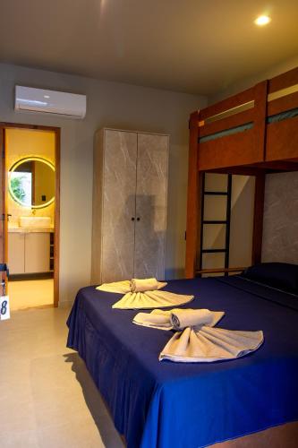 a bedroom with a blue bed with towels on it at Casa Ananda Hotel Boutique in Canoa Quebrada