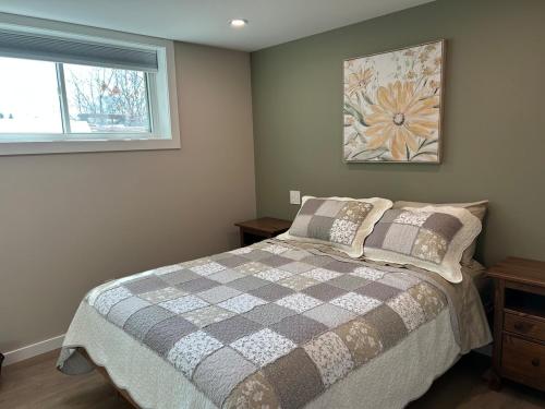 a bedroom with a bed and a window at The Basement Suite on Paradise Hill in Prince George