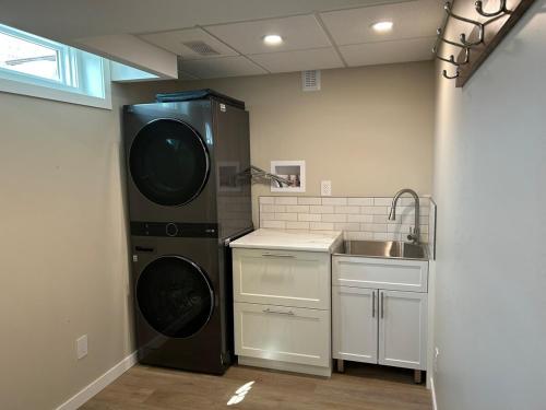 a kitchen with a dishwasher and a sink in it at The Basement Suite on Paradise Hill in Prince George