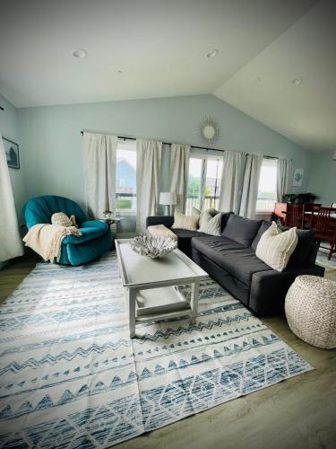 a living room with a couch and a table at Oceans3 - Spectacular View 'N' Jetty Access in Ocean Shores