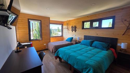 a bedroom with a bed and a bed and a couch at Cabañas y hostal Aurora in Castro