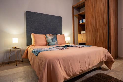 a bedroom with a bed with a large headboard at Costa Apartments in La Paz