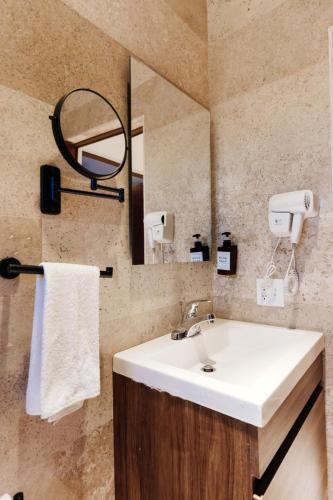 a bathroom with a sink and a mirror at Costa Apartments in La Paz
