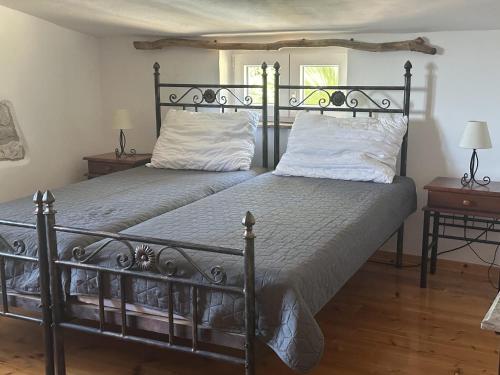 a bedroom with two beds with white pillows at Villa Doba - Visnjan in Višnjan