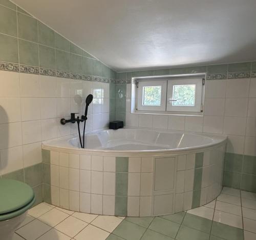 a bath tub in a bathroom with a window at Villa Doba - Visnjan in Višnjan