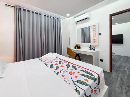 a hotel room with a bed and a desk at Evolve SAYA in Talawatugoda