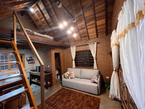 a living room with a couch and a loft at Cabana na Mata Paraíso da Serra in Aquidauana