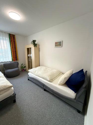 a bedroom with a bed and a couch and a chair at Haus Elisabeth in Nagold