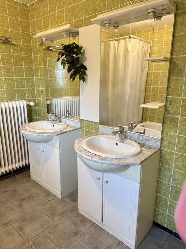 a bathroom with two sinks and a shower at Haus Elisabeth in Nagold