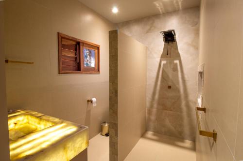a bathroom with a shower and a sink and a shower at Casa Ananda Hotel Boutique in Canoa Quebrada