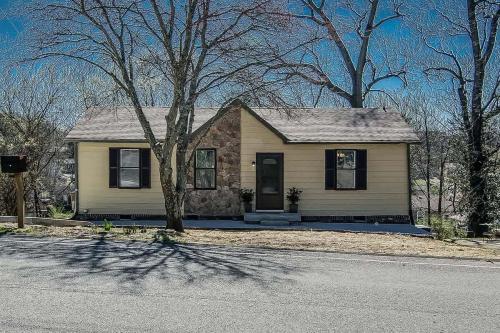 a yellow house with a tree in front of it at The Southern State of Mind by Stay Local Nashville in Nashville