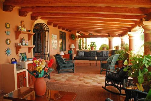 a living room with a couch and chairs and a table at La Valise Los Cabos in Boca de la Vinorama