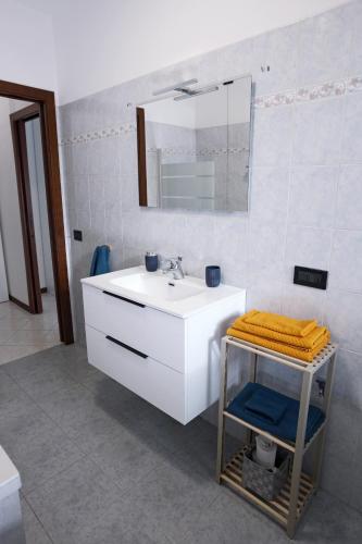 a bathroom with a white sink and a mirror at Armanni's House in Orio al Serio