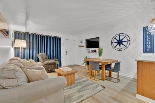 a living room with a couch and a table at Fenwick Woods OC in Ocean City