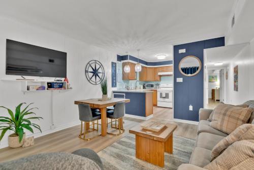 a living room with a couch and a table at Fenwick Woods OC in Ocean City