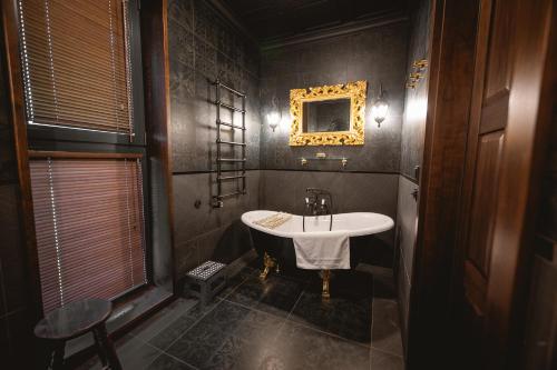 a bathroom with a tub and a sink at Sherlock Home in Czarnówiec