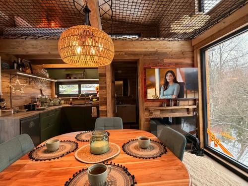 a dining room with a table in a kitchen at Sunny Garden House in Martinske Hole