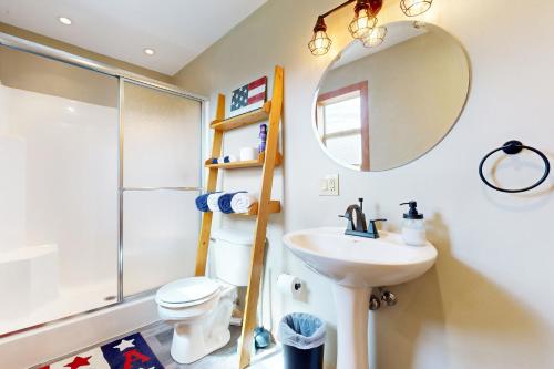 a bathroom with a sink and a mirror at Pet Friendly! Countryside Couples Stay in Illinois in Etherton