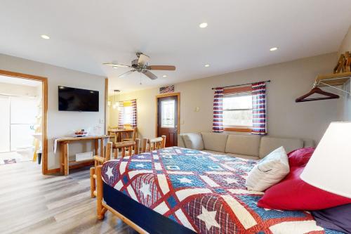 a bedroom with a bed and a couch and a television at Pet Friendly! Countryside Couples Stay in Illinois in Etherton
