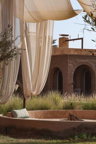 a group of white umbrellas in front of a building at Bliss Terra Janna in Marrakesh