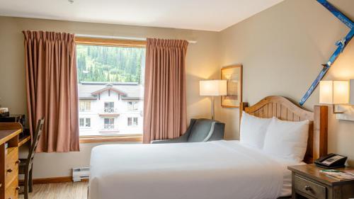a hotel room with a bed and a window at Cahilty #302 in Sun Peaks