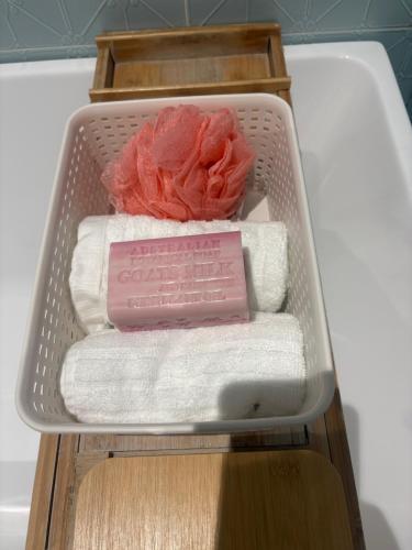 a drawer filled with towels and a pile of towels at Willow Place in Mornington
