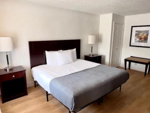 a bedroom with a large bed and two night stands at Airport Inn in Tulsa