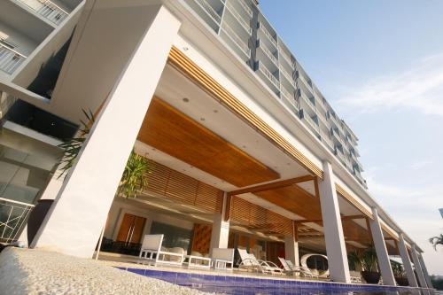 an external view of a building with a pool at Solea Mactan Resort in Mactan