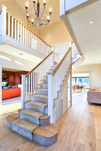 a staircase in a home with a chandelier at Wayside Farm in Staveley