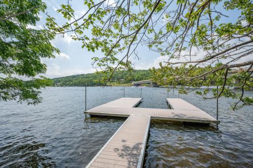 a dock in the middle of a lake at Whispering Pines by Railey Vacations in McHenry