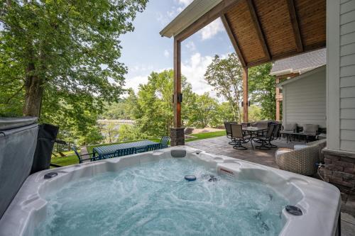 a hot tub on the patio of a house at Whispering Pines by Railey Vacations in McHenry