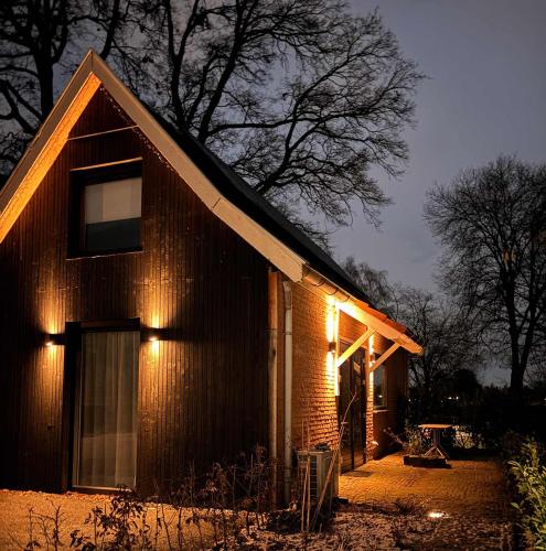 a house with lights on the side of it at Bommartini Guesthouse in Enschede