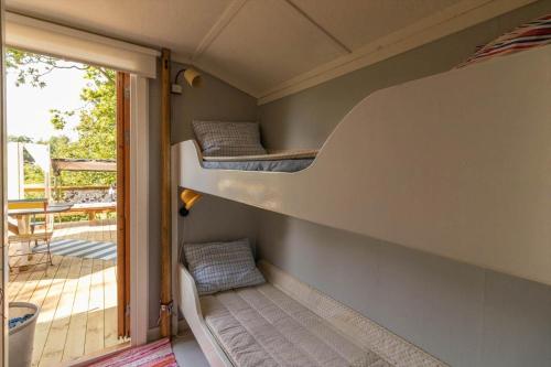 two bunk beds in a room with a balcony at BLE849-Ronneby-Rustorpsvaegen-1 in Ronneby