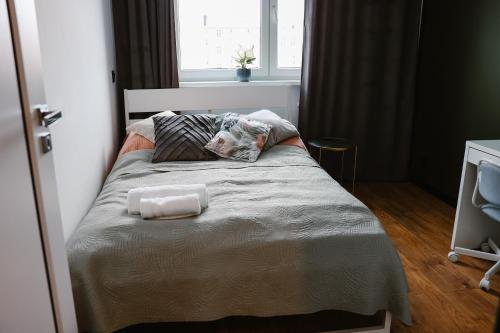 a bed in a bedroom with a dog pillow on it at Apartament Patka Wysoki STANDARD in Grudziądz