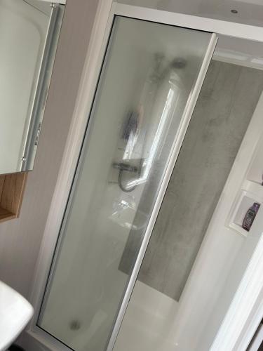 a sliding glass door with a sink in a kitchen at Dollys Den in Pagham