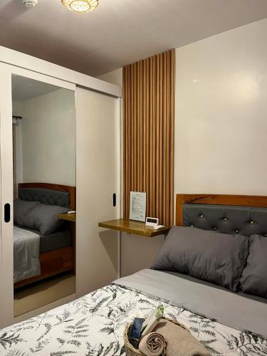 a bedroom with a large bed with a mirror at The Lotus Suite2 Iloilo in Iloilo City