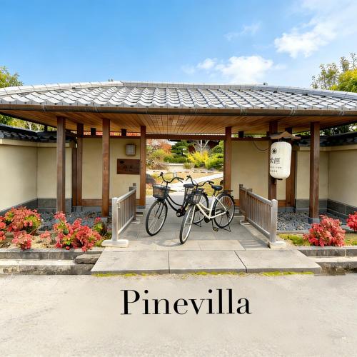 two bikes parked under a pavilion in a park at Kansai Airport Hotel Pine Villa in Kansai International Airport