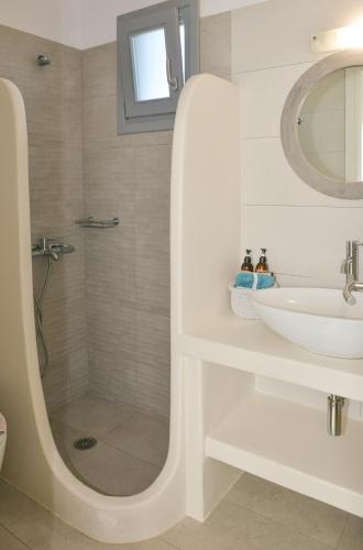 a white bathroom with a sink and a shower at Agros Estate in Plaka