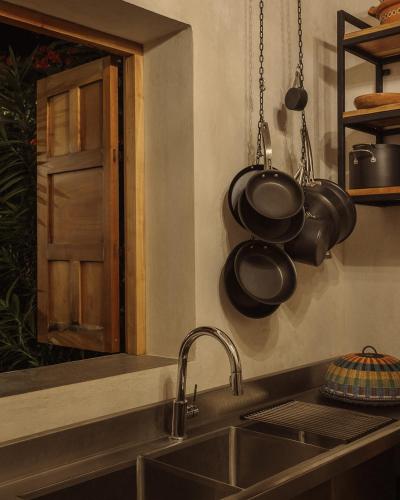 a kitchen with pots and pans hanging above a sink at Campeche Mágico in Campeche