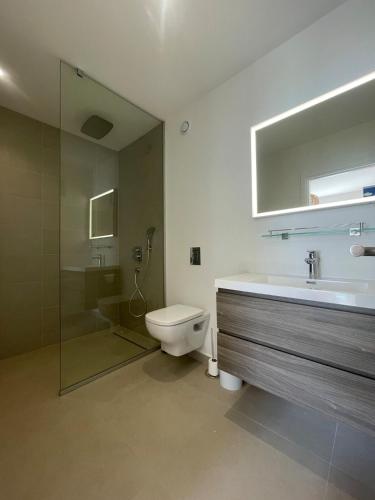 a bathroom with a toilet and a sink and a shower at White Sand Villa - infinity pool in Paea