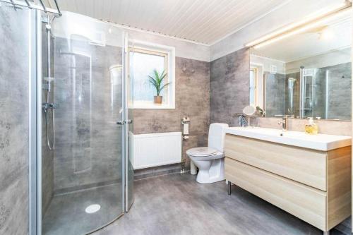 a bathroom with a shower and a sink and a toilet at VGO959-Kalv-Gunnarpsvaegen-3 in Kalv