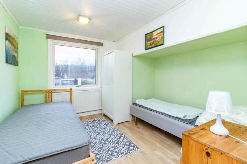 a small bedroom with a bed and a window at VGO959-Kalv-Gunnarpsvaegen-3 in Kalv