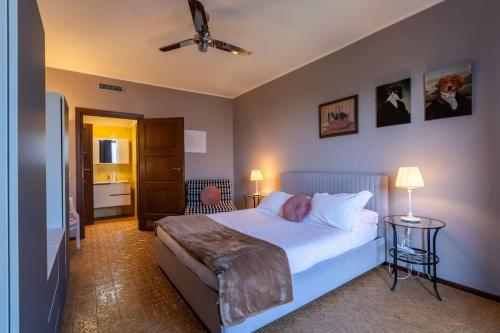 a bedroom with a bed with a person laying on it at Ca Maria Peonie Apartment in Bellagio